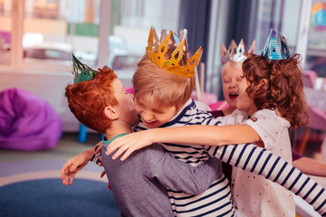 Happy kids wearing paper crowns during party