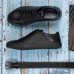 Black leather male shoes and belt on wooden background, top view