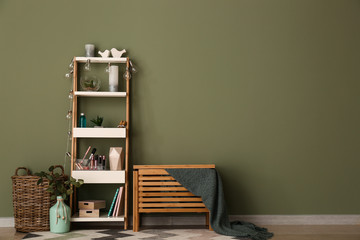 Modern interior of room with stylish furniture near color wall