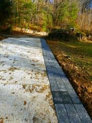 Pavoirs being laid at the side of a new concrete drive in the countryside