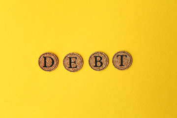 Word DEBT on color background