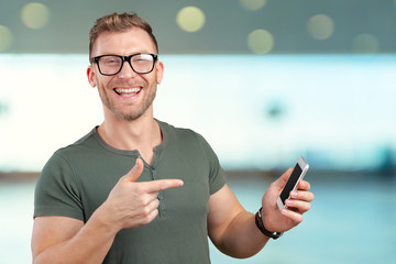 Portrait of casual businessman holding hand mobile phone