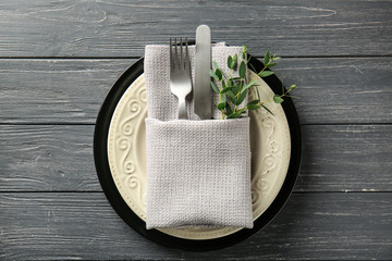 Beautiful table setting with floral decor on wooden background