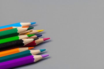 Naklejka premium Colorful pencils arrangement on grey background close up