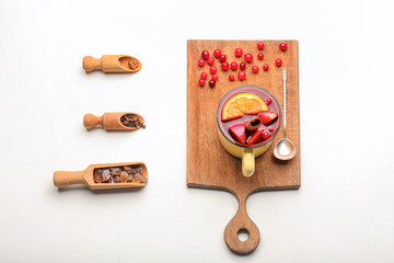 Composition with mug of tasty mulled wine on white background