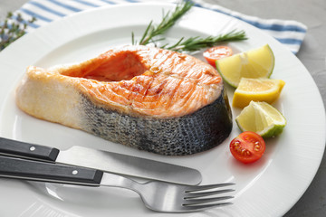 Tasty grilled salmon steak on plate