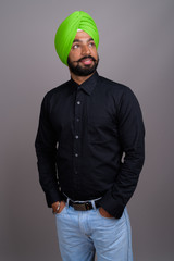Young Indian Sikh businessman wearing green turban