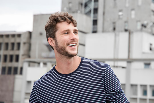 Happy Guy In City, Smiling And Looking Away