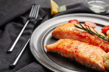 Pieces of tasty grilled salmon on plate, closeup