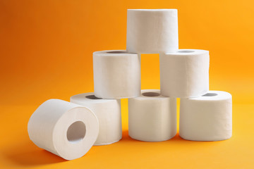 Rolls of toilet paper on color background