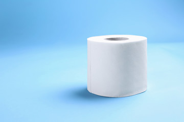 Roll of toilet paper on color background
