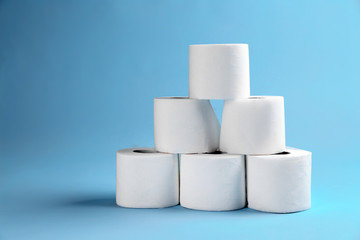 Rolls of toilet paper on color background