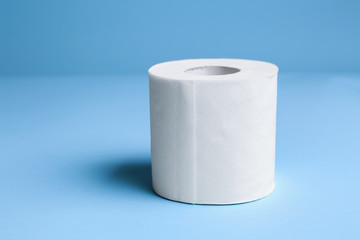 Roll of toilet paper on color background