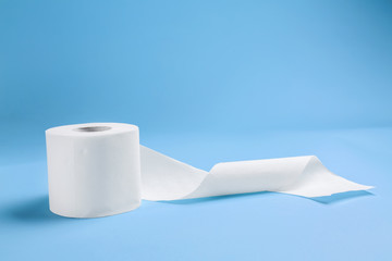 Roll of toilet paper on color background