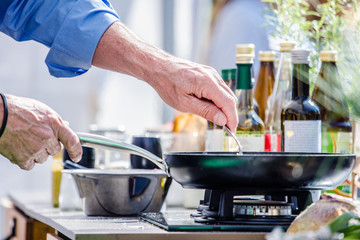 Chefs at work in a restaurant kitchen making delicious food
