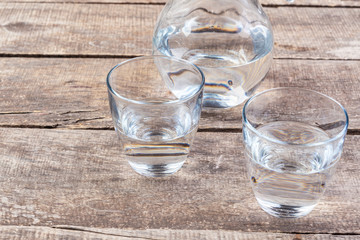 Glasses of water on a wooden table.