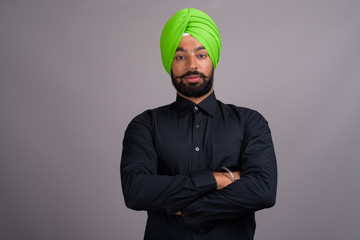 Young Indian Sikh businessman wearing green turban