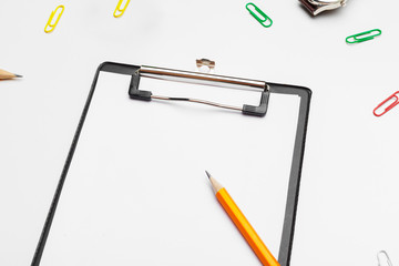 Clipboard with white sheet and pen isolated on a white background. Top view