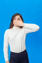 Young beautiful girl isolated on blue background