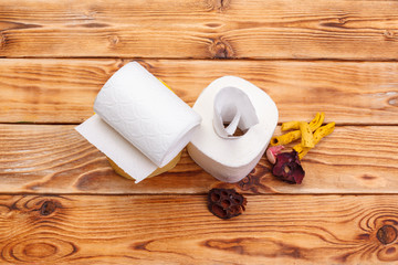 Toilet paper rolls on wooden background top view
