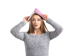 Beautiful young woman with book on white background