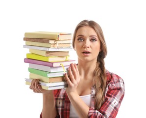 Beautiful young woman with stack of books on white background