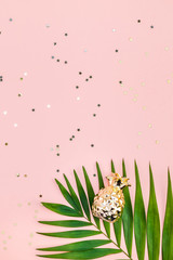 Creative pink background with tropical palm leaves