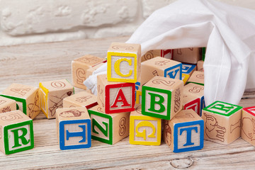 Multicolored wooden toy blocks on wooden background