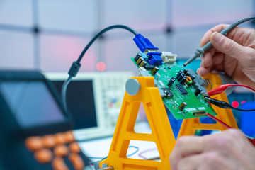Fixing electronics PCB board in service /  workbench with electronics measuring instruments