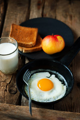 Breakfast  fried Eggs with toast apple and milk