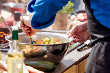 Chefs at work in a restaurant kitchen making delicious food