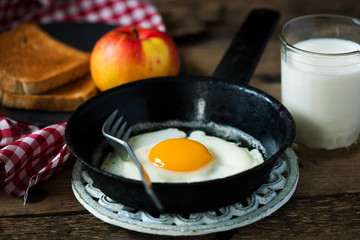 Breakfast  fried Eggs with toast apple and milk