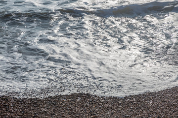 The sea lapping the pebble beach in Hove, Sussex