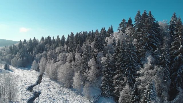 Snowfall of holls, forests and frozen river
