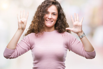 Beautiful brunette curly hair young girl wearing pink sweater over isolated background showing and...