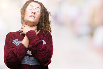 Beautiful brunette curly hair young girl wearing glasses over isolated background shouting and suffocate because painful strangle. Health problem. Asphyxiate and suicide concept.
