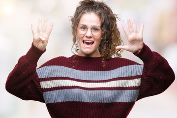 Beautiful brunette curly hair young girl wearing glasses over isolated background showing and...