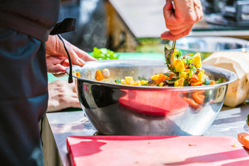 Chefs at work in a restaurant kitchen making delicious food