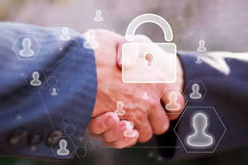 Business button lock security on background business partnership handshake concept. Two coworkers handshaking process of interaction.