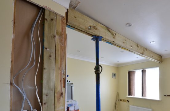 A wooden Beam support holding up a ceiling