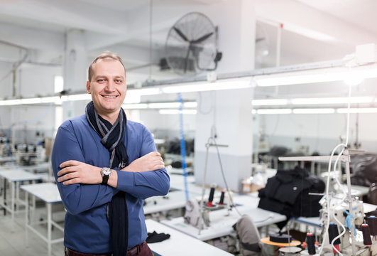 Small Business Owner Posing In Factory.