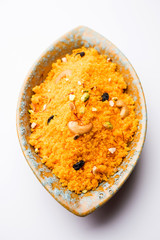 Badaam kesar shira / Sheera or almond saffron halwa, popular Indian dessert served in a bowl. selective focus