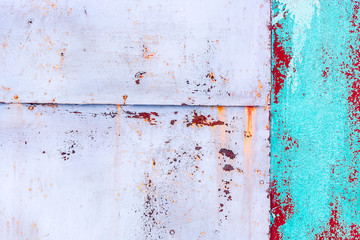 Rusty metal sheets with peeling paint