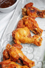 Fried chicken with BBQ sauce on a wooden background.