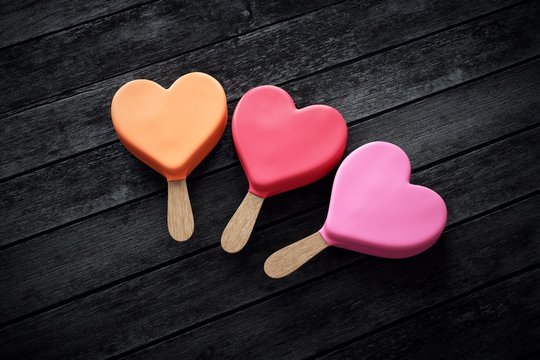 Three heart-shaped ice creams in pink colors
