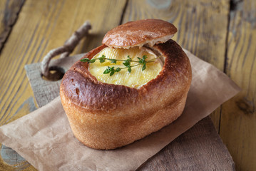 Camembert bread bowl on the wooden background