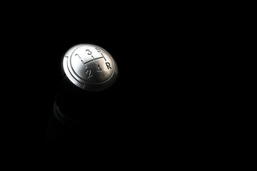 Close up view of a manual gear lever shift isolated on black background. Manual gearbox. Car...