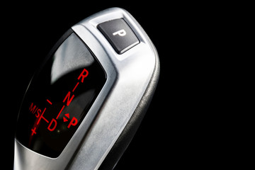Automatic gear stick of a modern car isolated on white background. Modern car interior details....