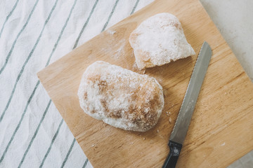 Bread and knife on kitchen table.