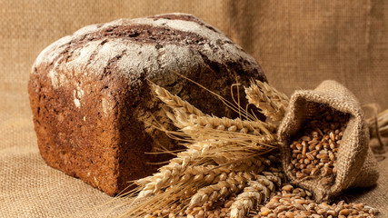 Retro bread in rustic style background.Fresh traditional bread on wooden ground with flour in a...
